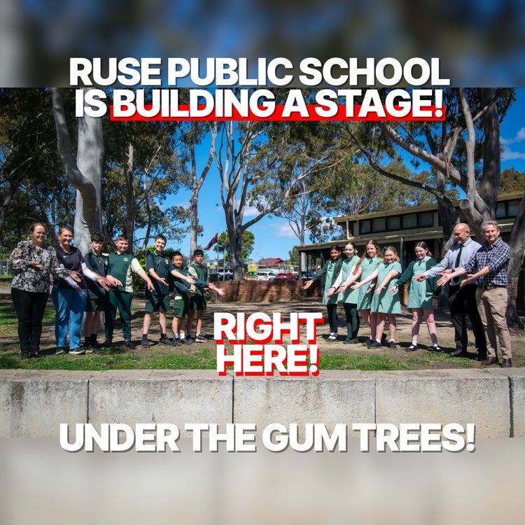 a group of students and teachers all pointing to the ground where the new stage is going to be built.